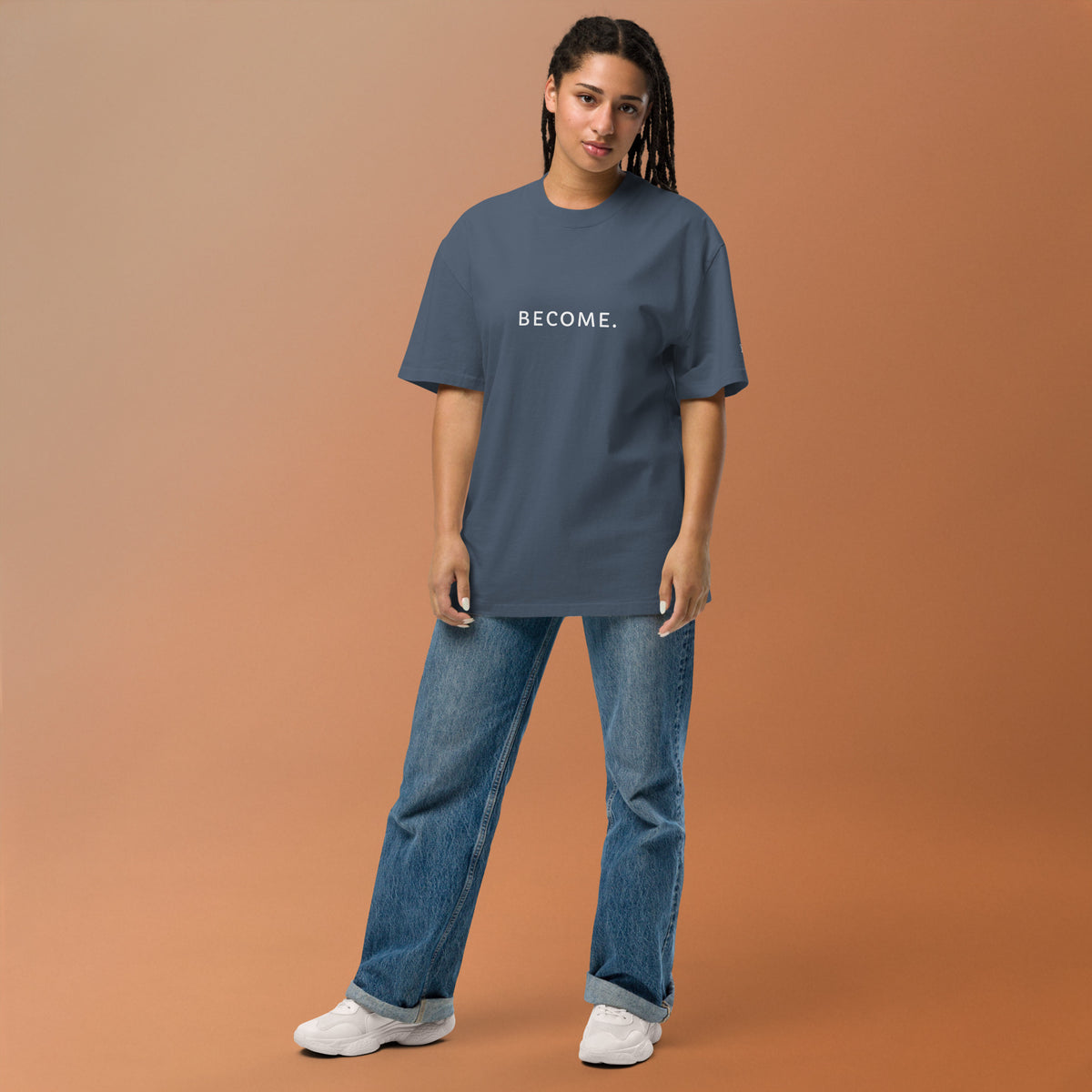 Model wearing the BECOME. Oversized Faded Tee in Faded Indigo, front view with BECOME. printed across the chest