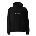 BECOME. Oversized Hoodie in Black, front view with BECOME. printed across the chest