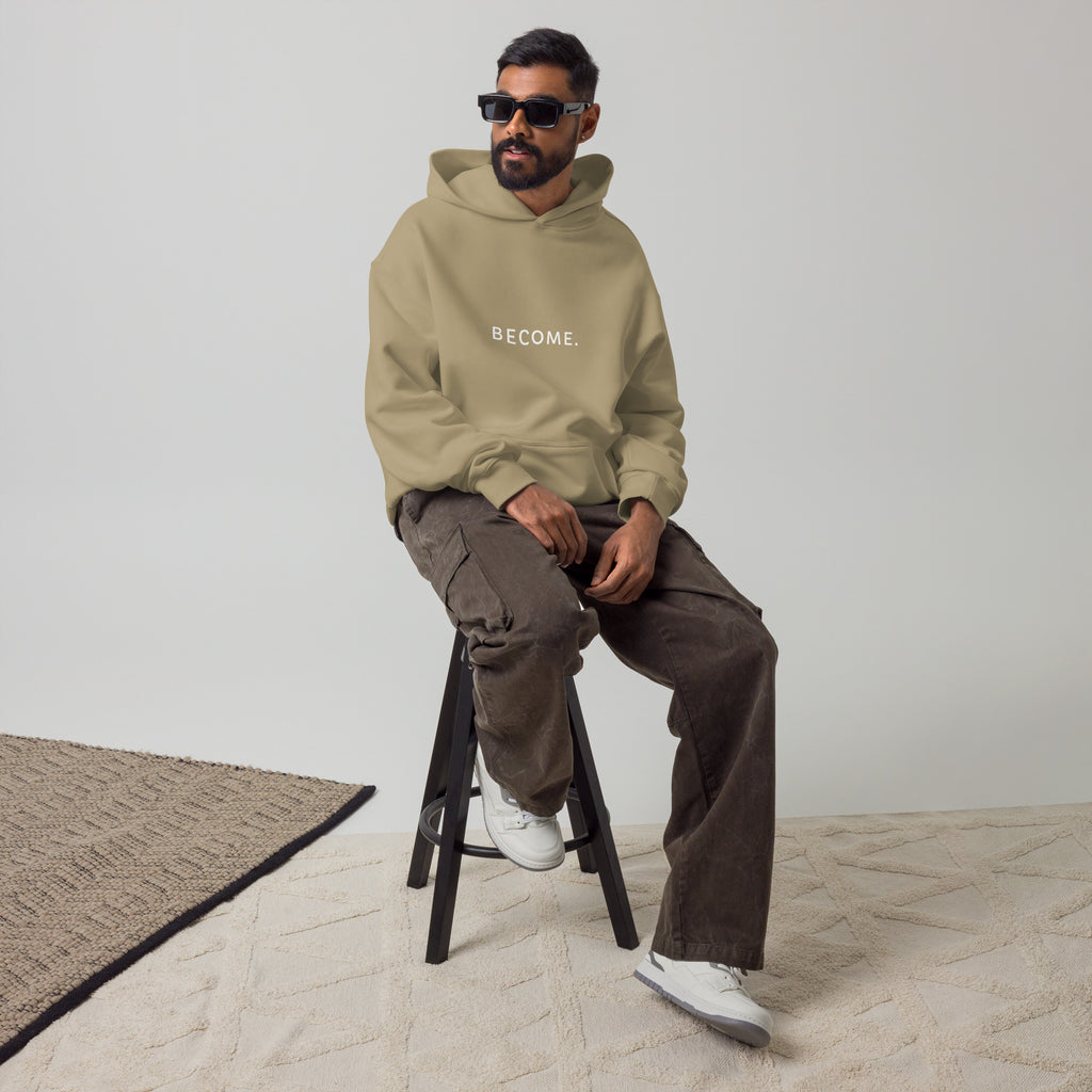BECOME. Oversized Hoodie in Sand, front view with BECOME. printed across the chest